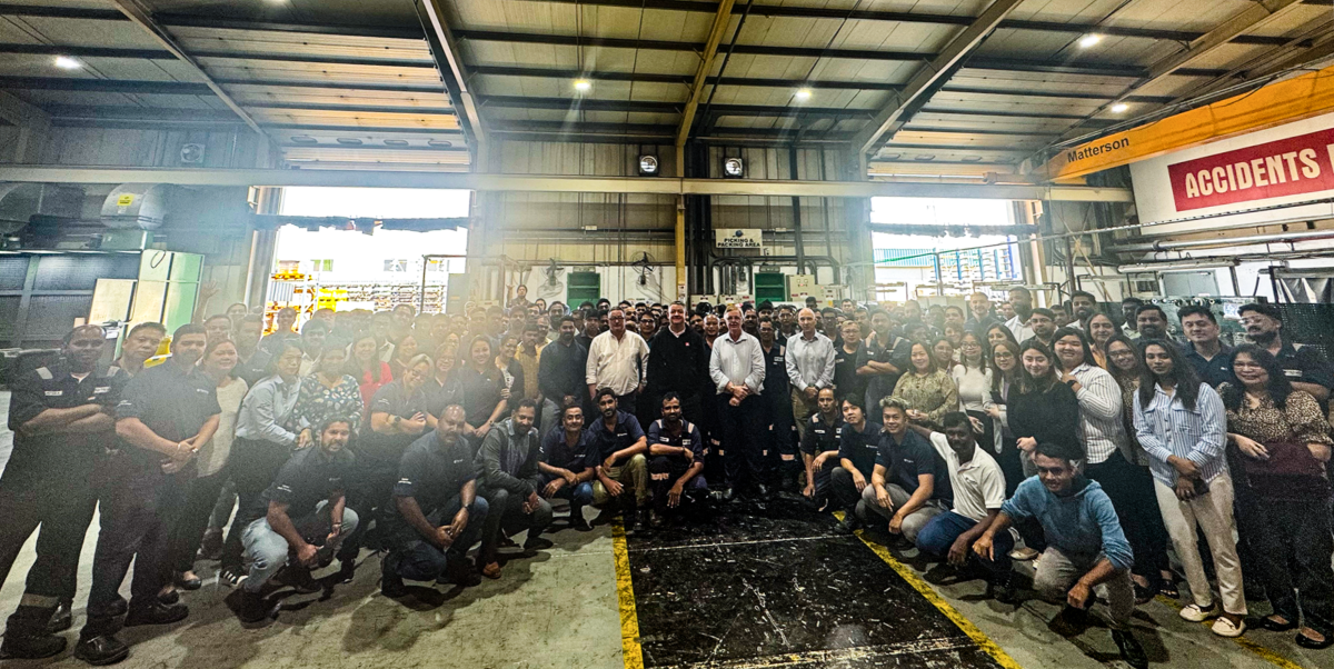 A large group of TripleFast Middle East employees gathered inside a warehouse for the January Employee Town Hall